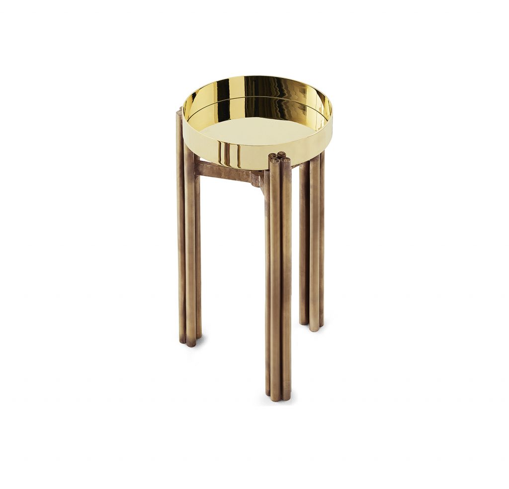 table made of burnished brass base and marble top in a golden tone on a white background