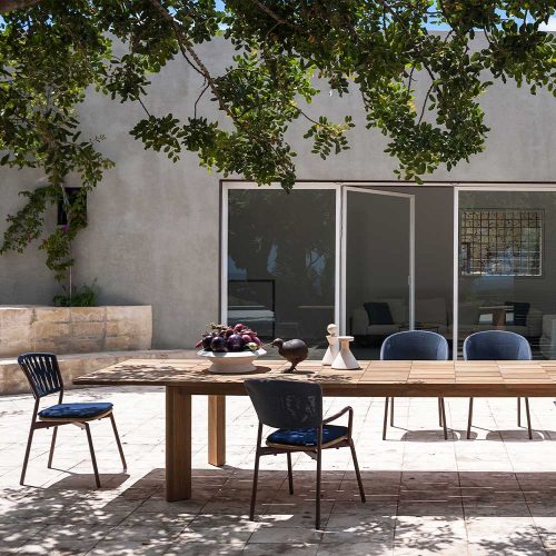 long dining table made of a light brown wooden base with a design in the form of squares or blocks