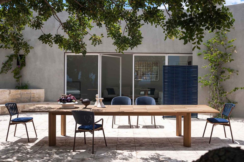 long dining table made of a light brown wooden base with a design in the form of squares or blocks