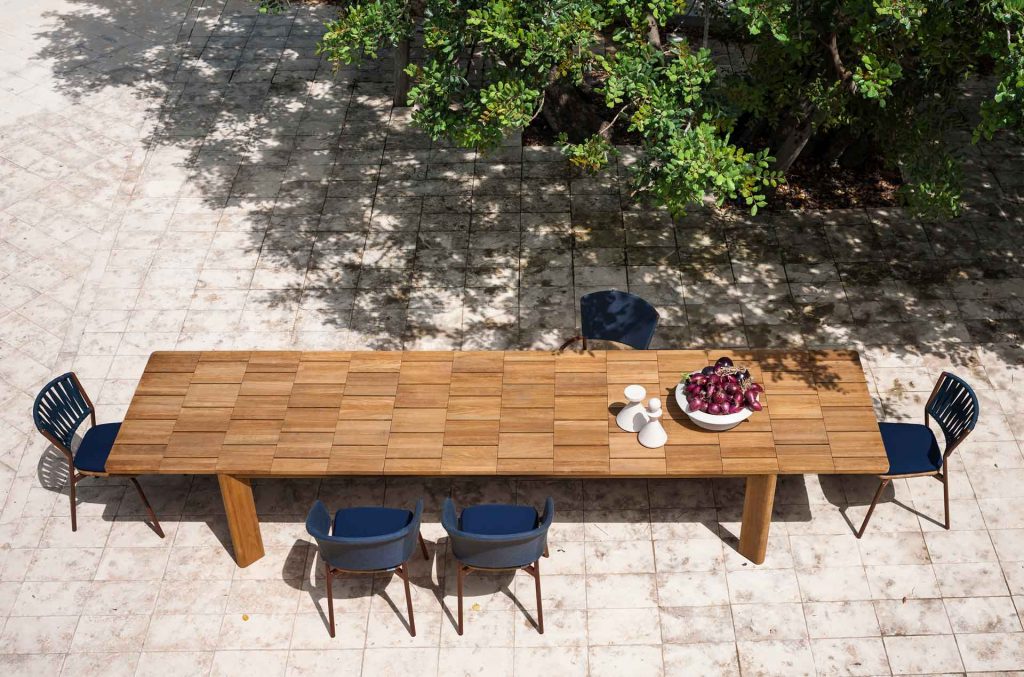 long dining table made of a light brown wooden base with a design in the form of squares or blocks