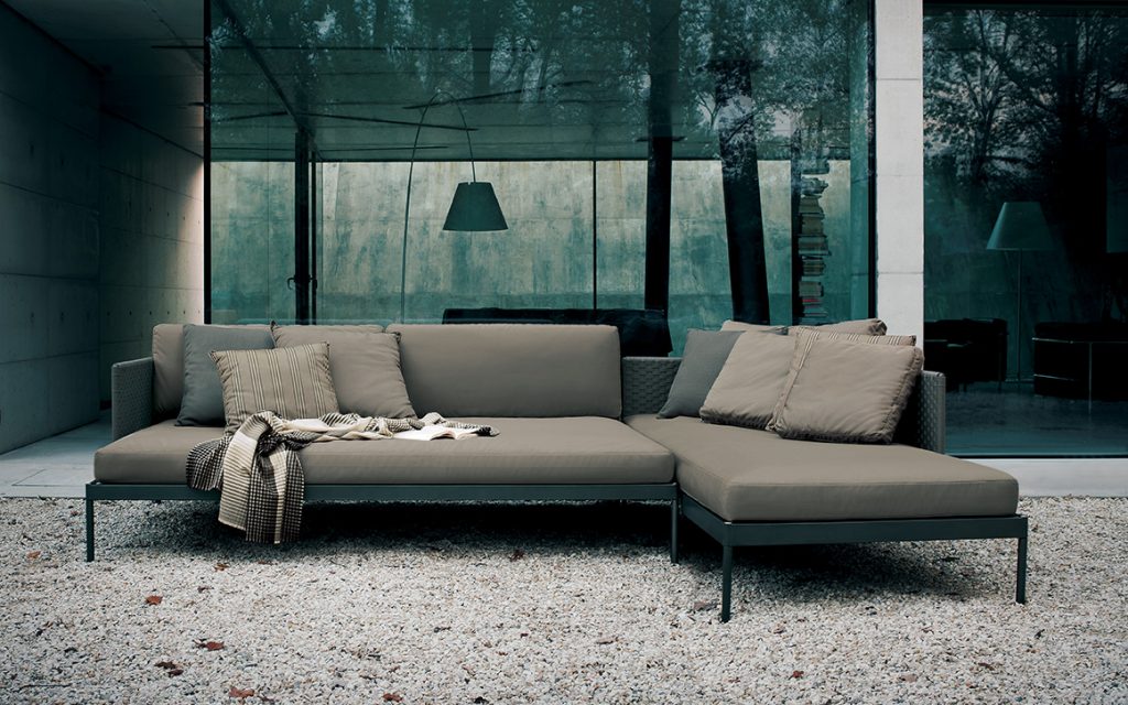 sofa made in the shape of an L in a dark gray and beige color tone on the outside