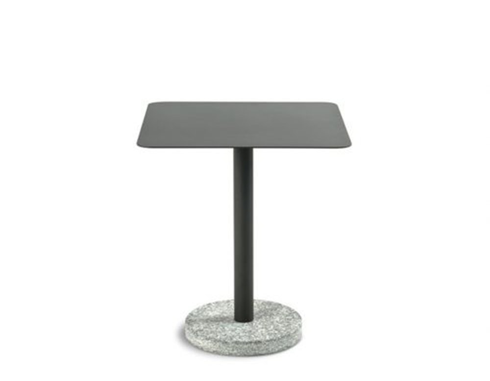 A square outdoor coffee table with a matte black top, slim pedestal stem, and solid circular granite base for grounded elegance.
