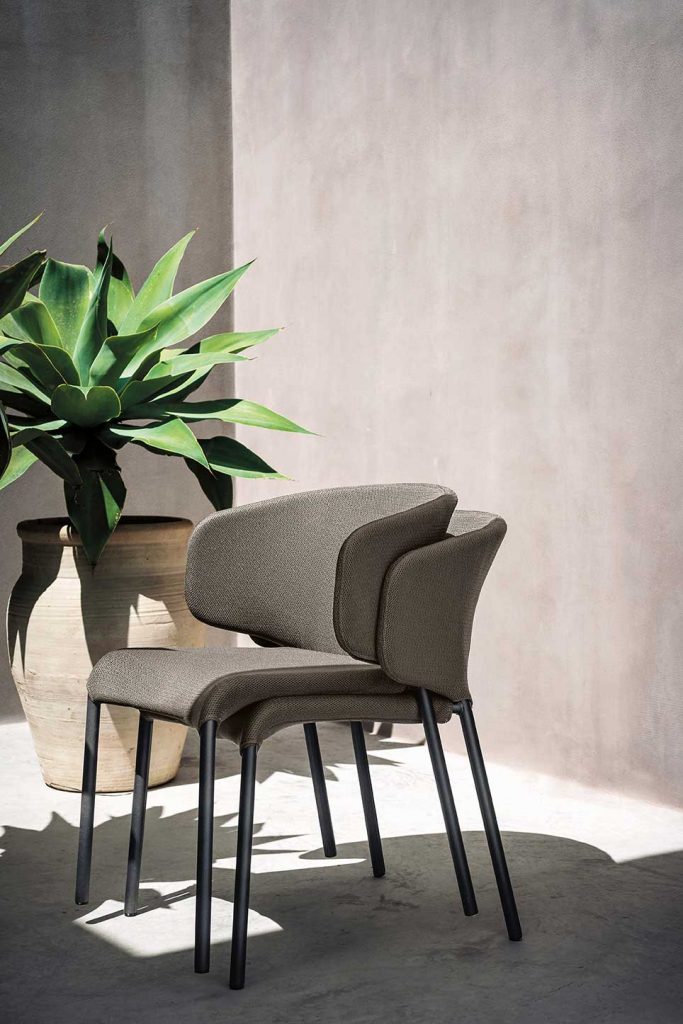 two chairs on top of each other in a gray tone and black base