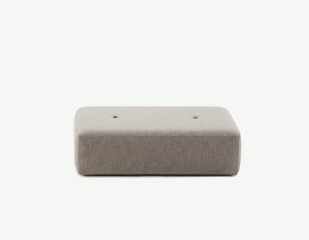 A large rectangular outdoor pouf in light taupe fabric, featuring soft edges and three subtle tufted accents.