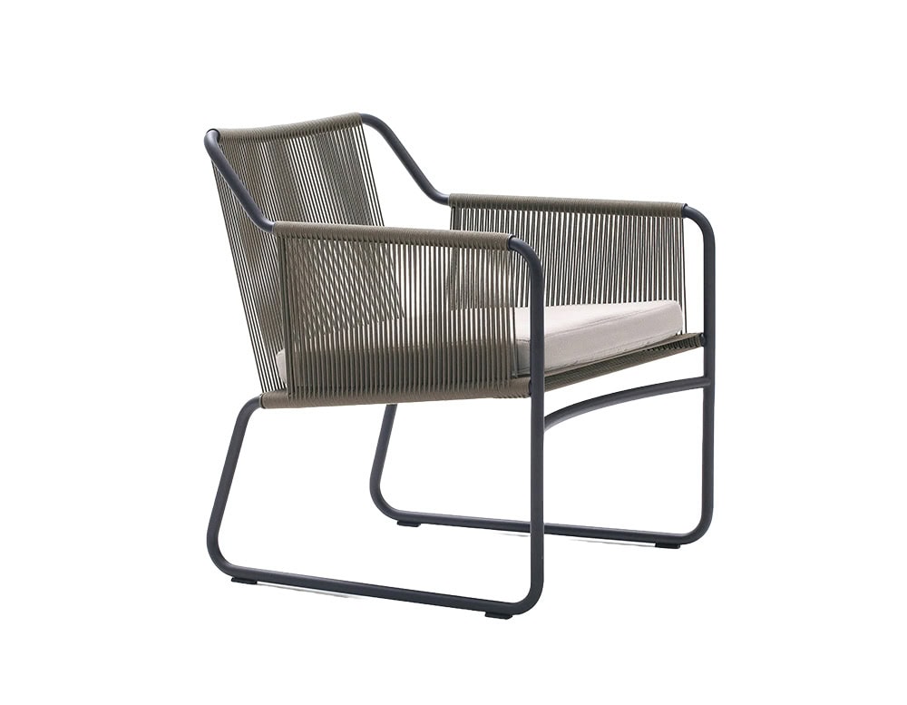 A modern outdoor lounge chair with a charcoal metal frame, olive rope weave, and a light beige cushion seat.