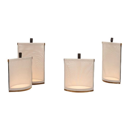 Rod Pillow Lantern brings gentle illumination through fabric-wrapped frames with wooden accents and handles for easy placement outside.