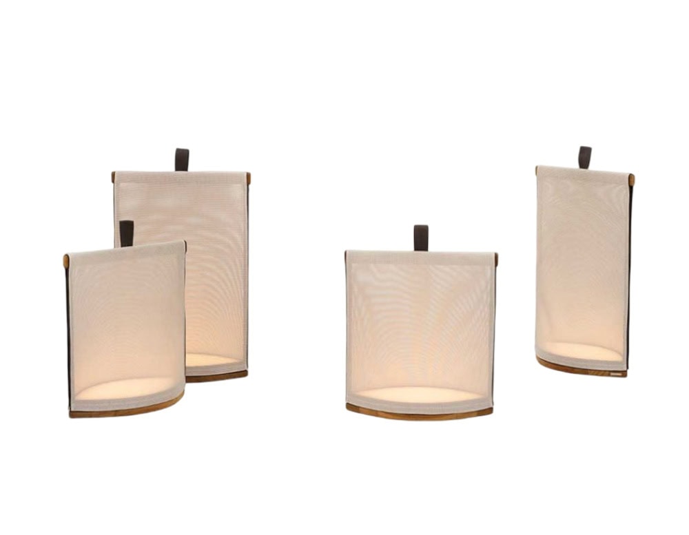 Rod Pillow Lantern features soft, fabric-covered lanterns with warm glow and simple handles, perfect for creating ambient outdoor lighting.