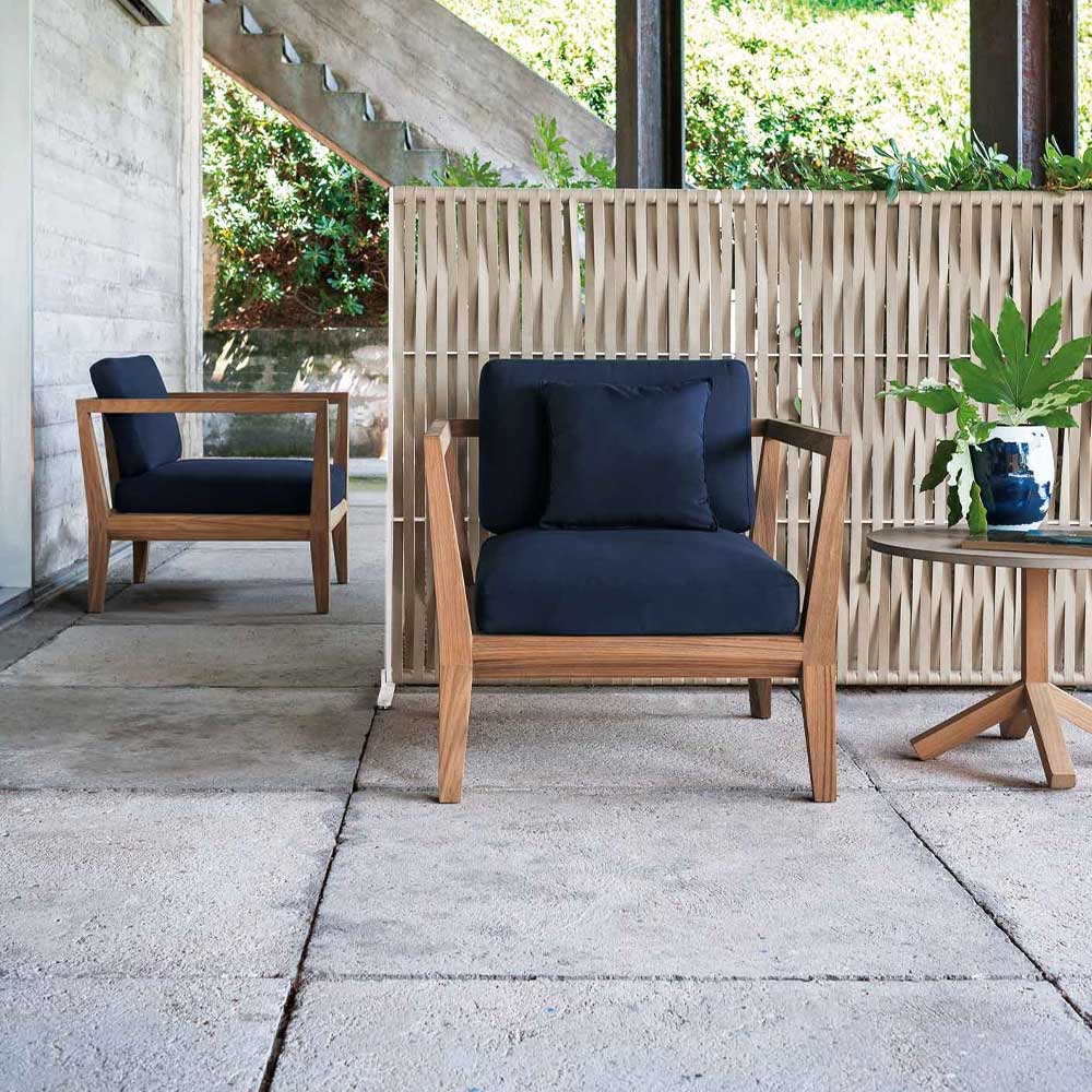 Teka Ten Sofa one in the foreground next to a side table and one in the background on a patio