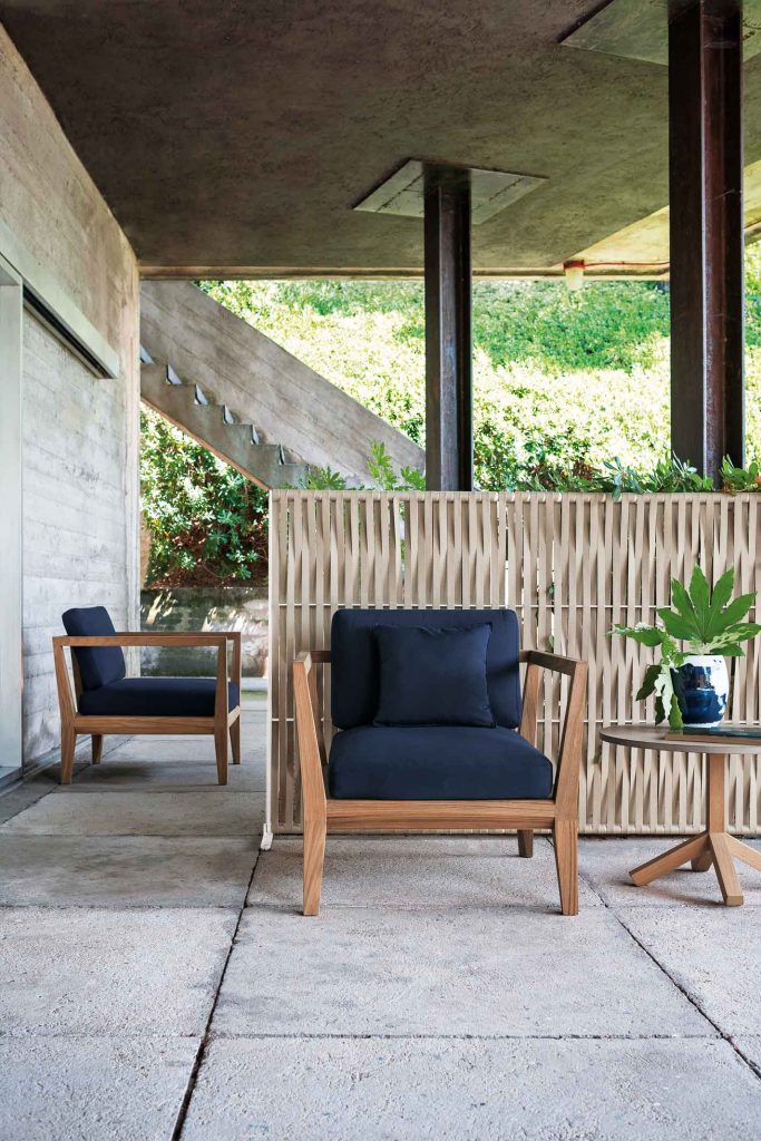 Teka Ten Sofa one in the foreground next to a side table and one in the background on a patio