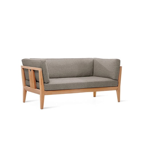Rod Teka sofa combines a warm teak wood frame with tailored grey cushions, creating a balanced blend of comfort, durability, and understated elegance for versatile outdoor living.