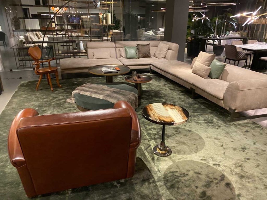 Studio NYC Pearl large area rug with a leather armchair, sofa, and coffee table on top