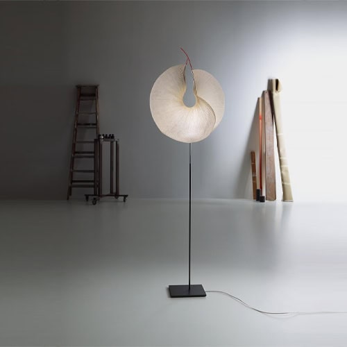 A Yoruba Rose lamp that is on a stand in a room