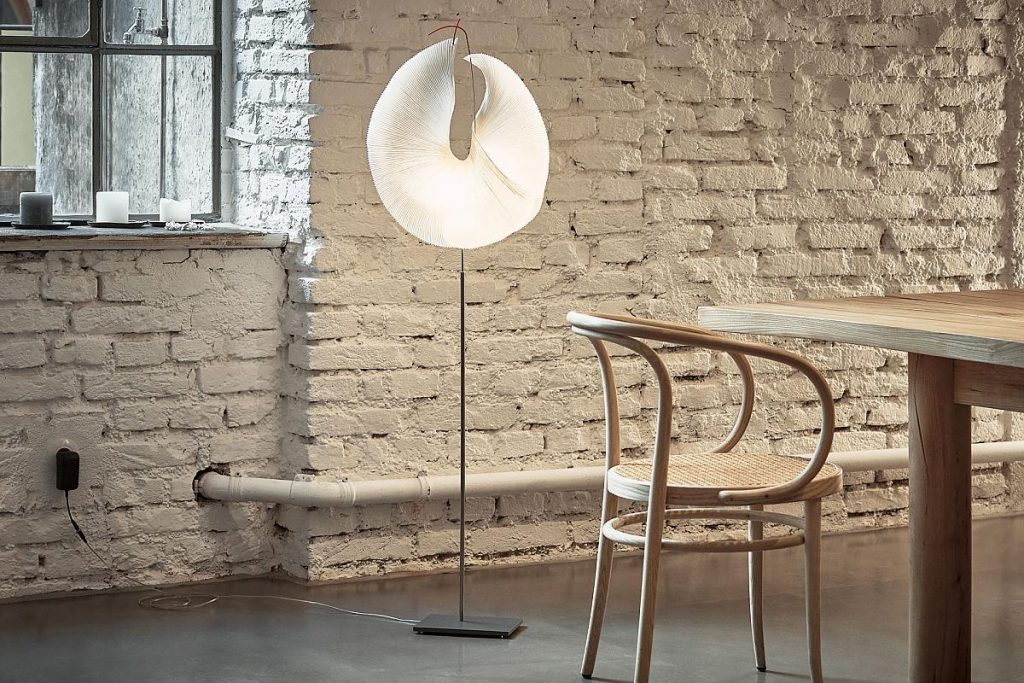 A room with a table a chair and a Yoruba Rose lamp