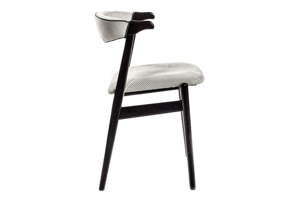 Side view of Unique small armchair in front of a white background