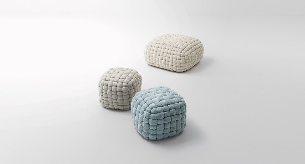 Three Tobit in blue, grey, and cream in front of a grey background