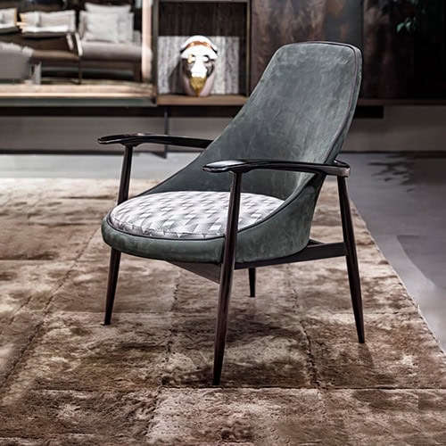 armchair upholstered in emerald-colored leather on a wooden structure in a brown tone