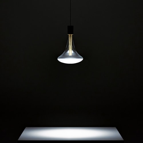 Cathode light illuminating a small white table in a dark room