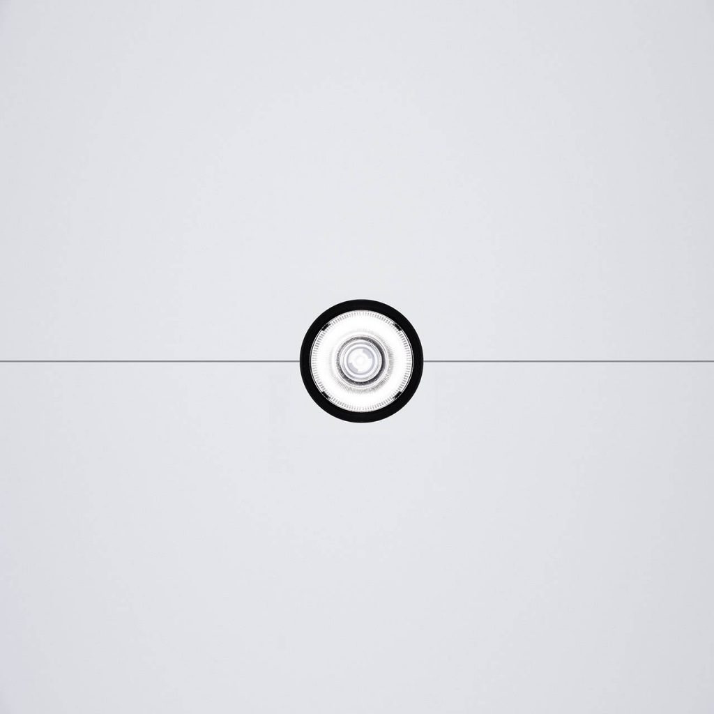 Close up of underneath of Ohm light in front of a white background