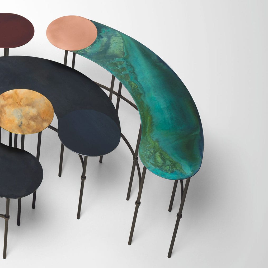 Top view of Scribble table next to another table in black on a white floor