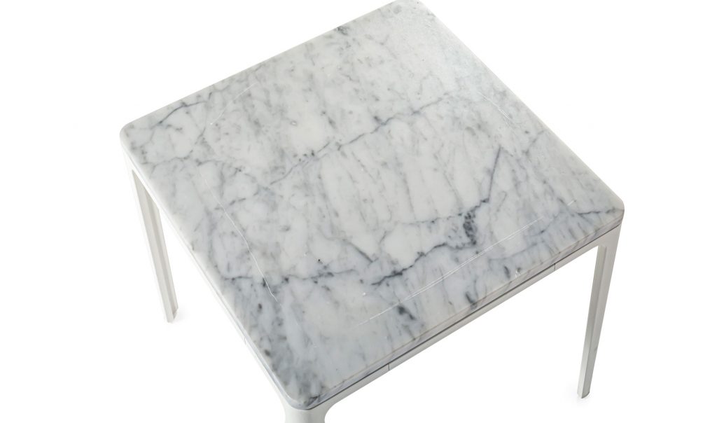 Top angle of marble top of Plate side table in front of a white background