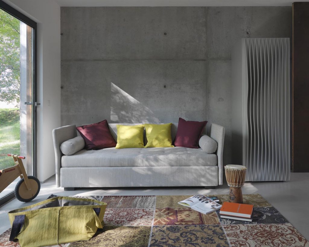 Grey Figi with two lime green pillows and two purple pillows on top