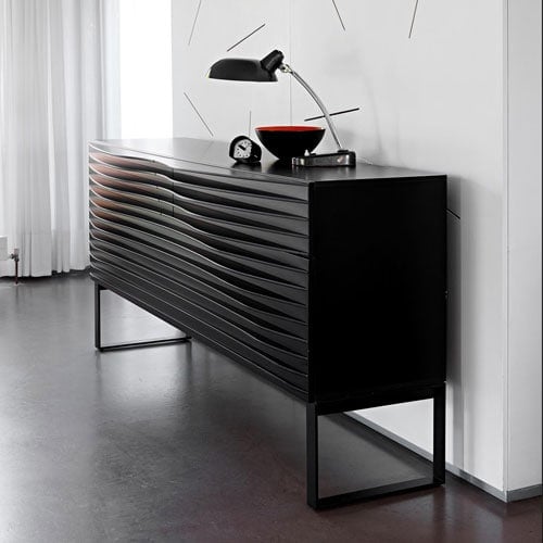 Tide in black color against a white wall