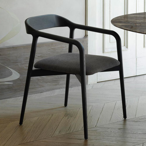 Velasca next to a table on wooden flooring