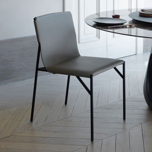 Tout Le Jour Chair next to a glass table