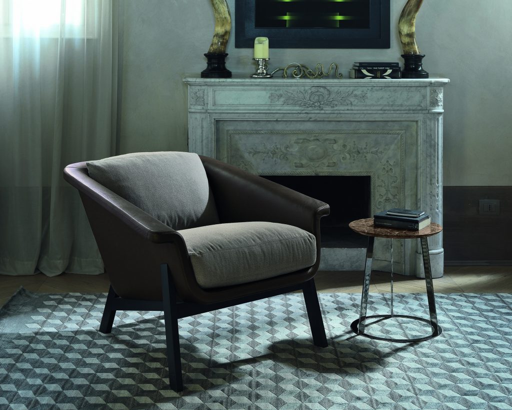 Albino Family small brown top next to a cream chair over a patterned rug