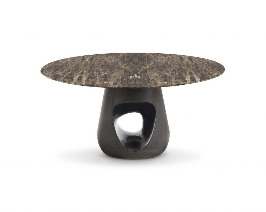Barbara with a small flat marble top in front of a white background