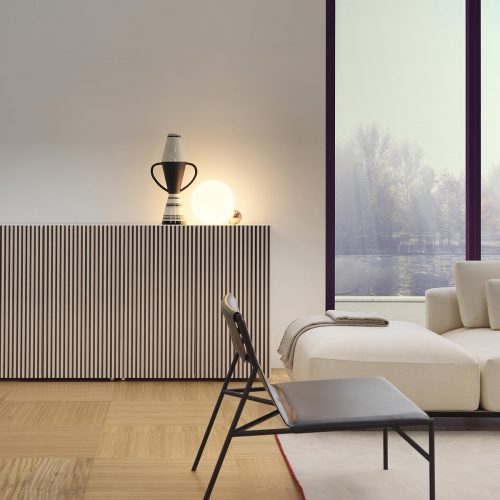 Leon Decor in grey with a white couch in front of it