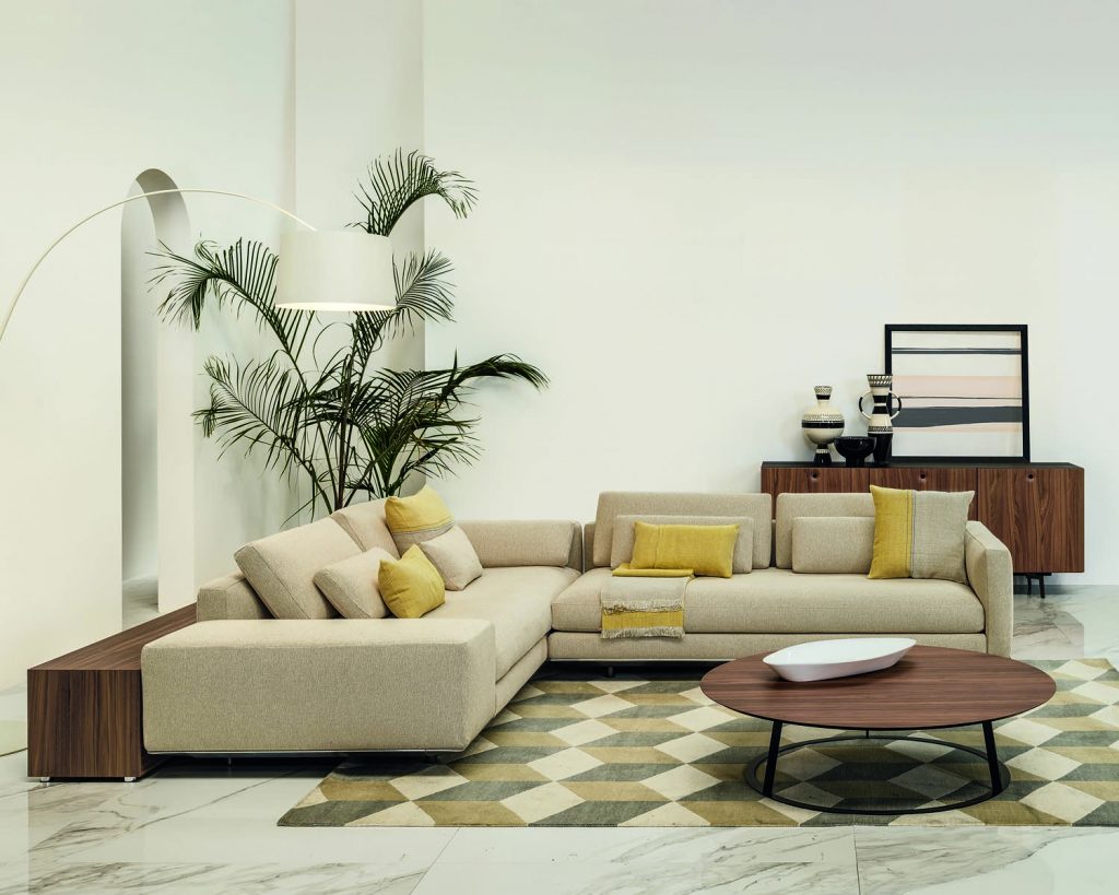 Cream colored Miles sofa on a cream colored rug with multicolored patterns
