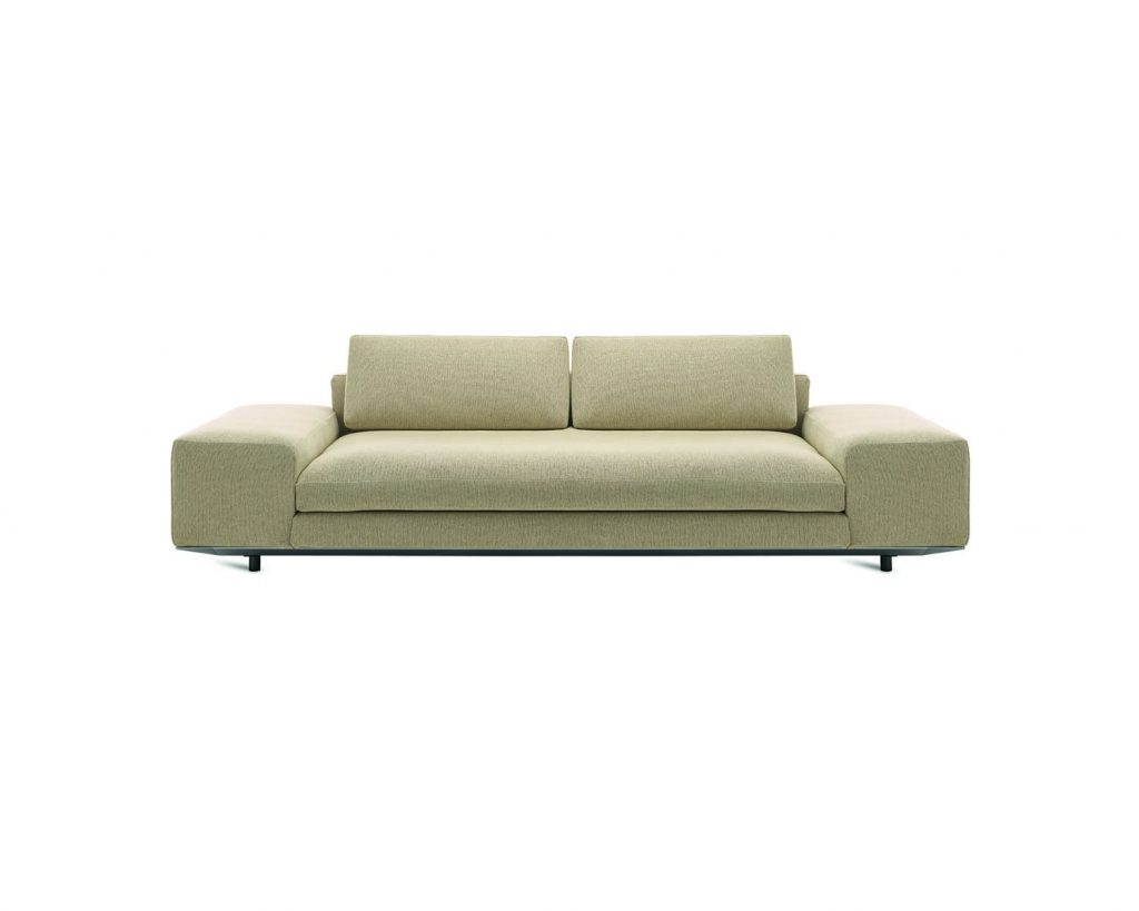 Cream-colored Miles with wide flat armrests in front of a white background