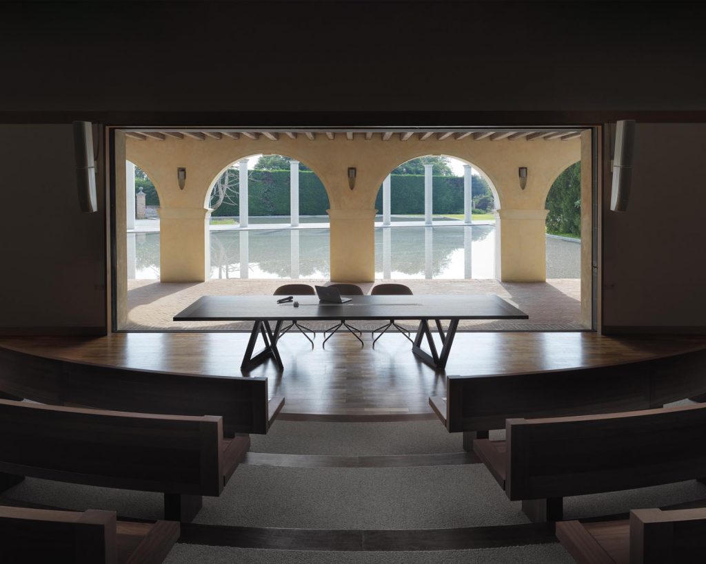 Quadror Three in a large room with windows behind it and