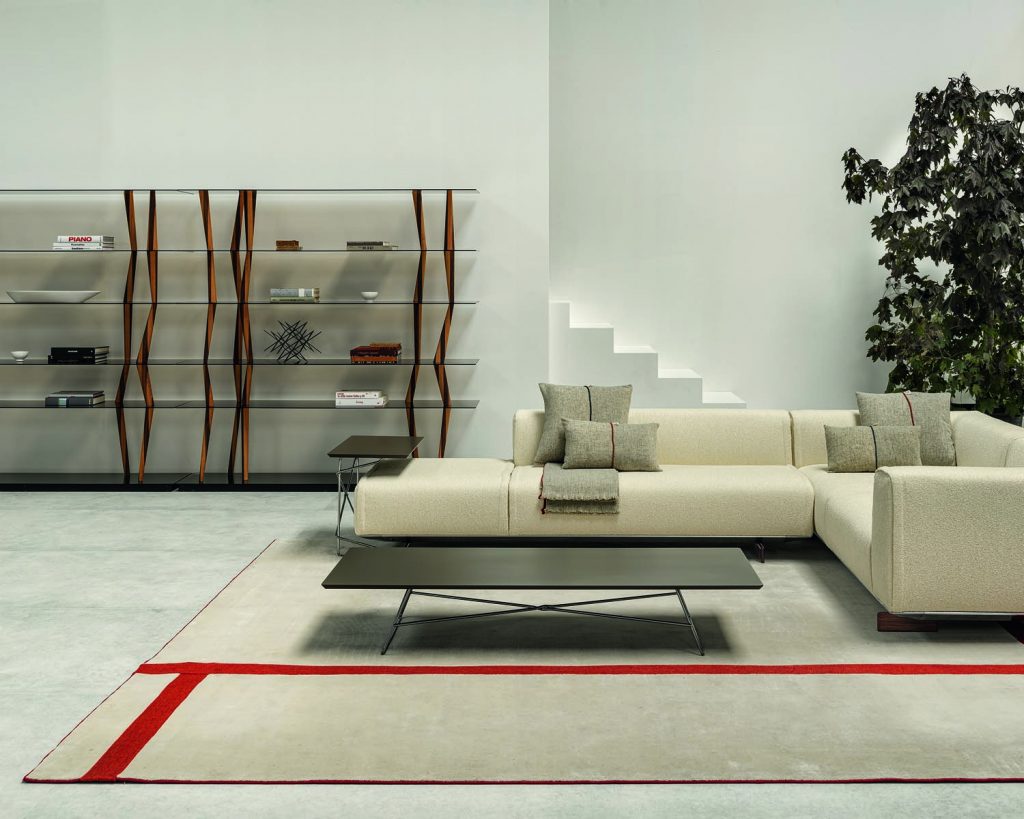 Sendai in the background of a living room against a cream wall and a cream couch in front of it