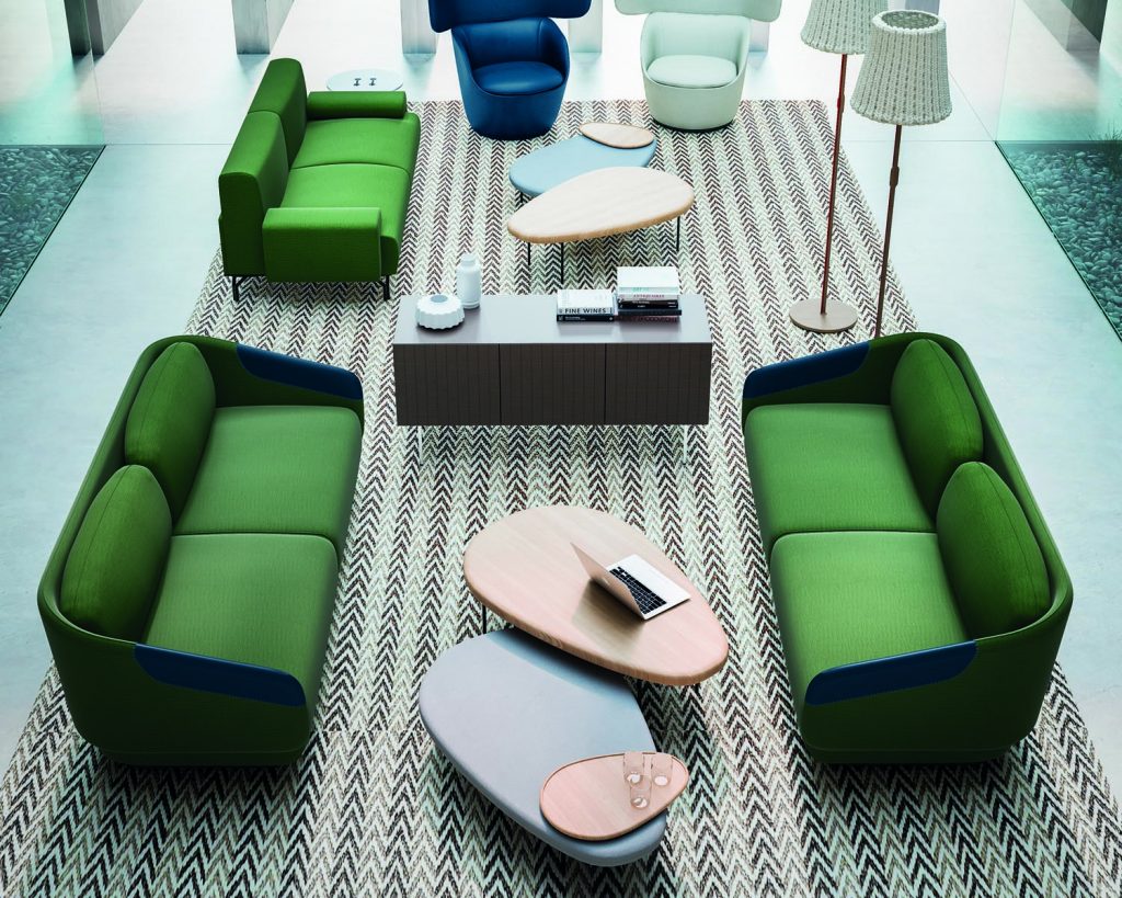 Top angle Worn green couches facing each other with tables between the couches