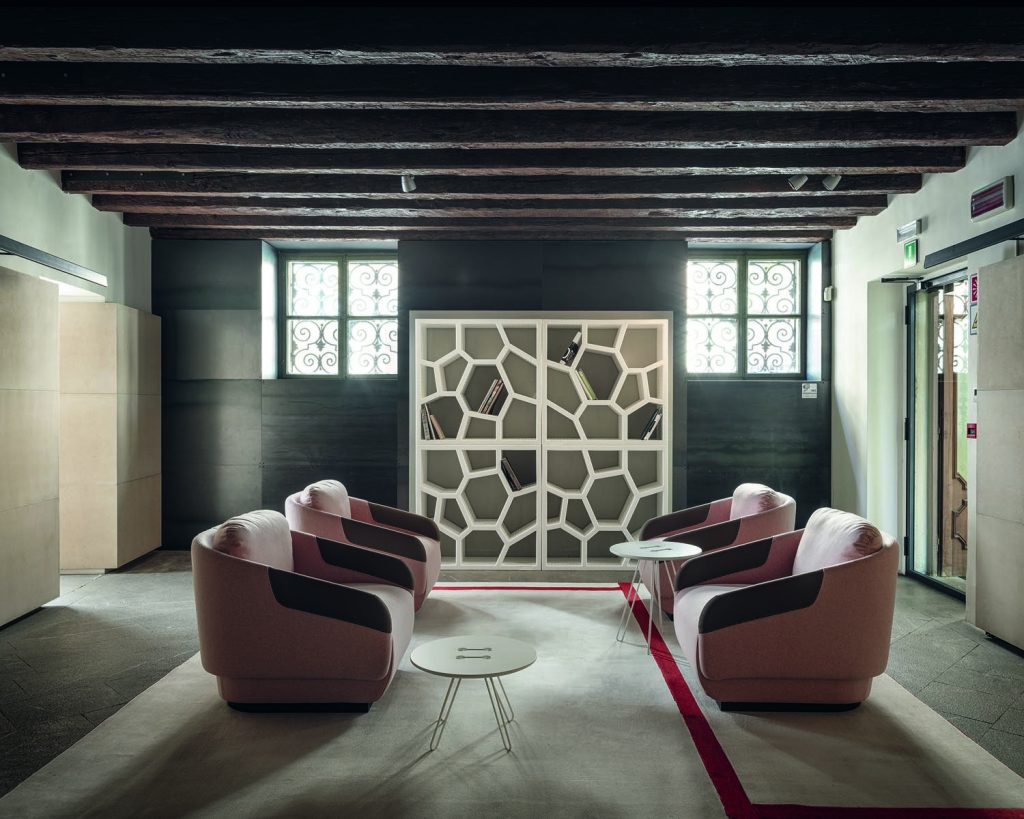 Quad pink Worn chairs on a rug facing each other