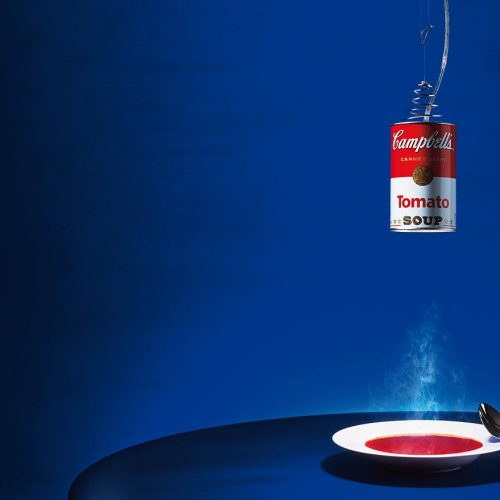 A plate on top of a table with a Canned Light hanging over it