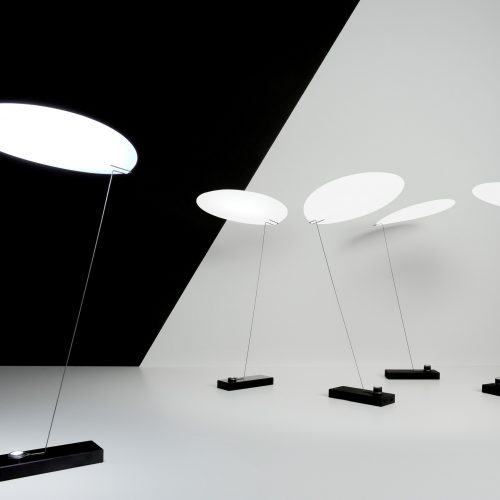 Five Koyoo illuminated standing in front of a black and white background
