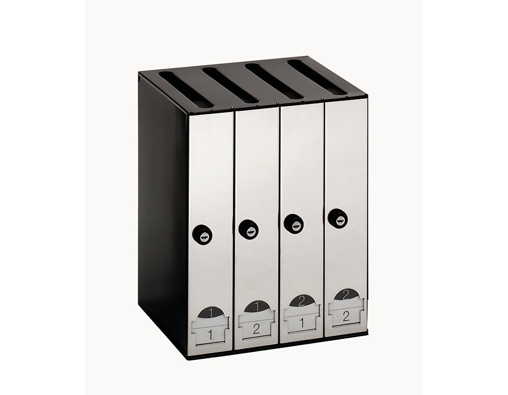 A modular set of four vertical stainless steel mailboxes with black frames, each featuring individual locks, numbered label holders, and top slots for mail insertion.