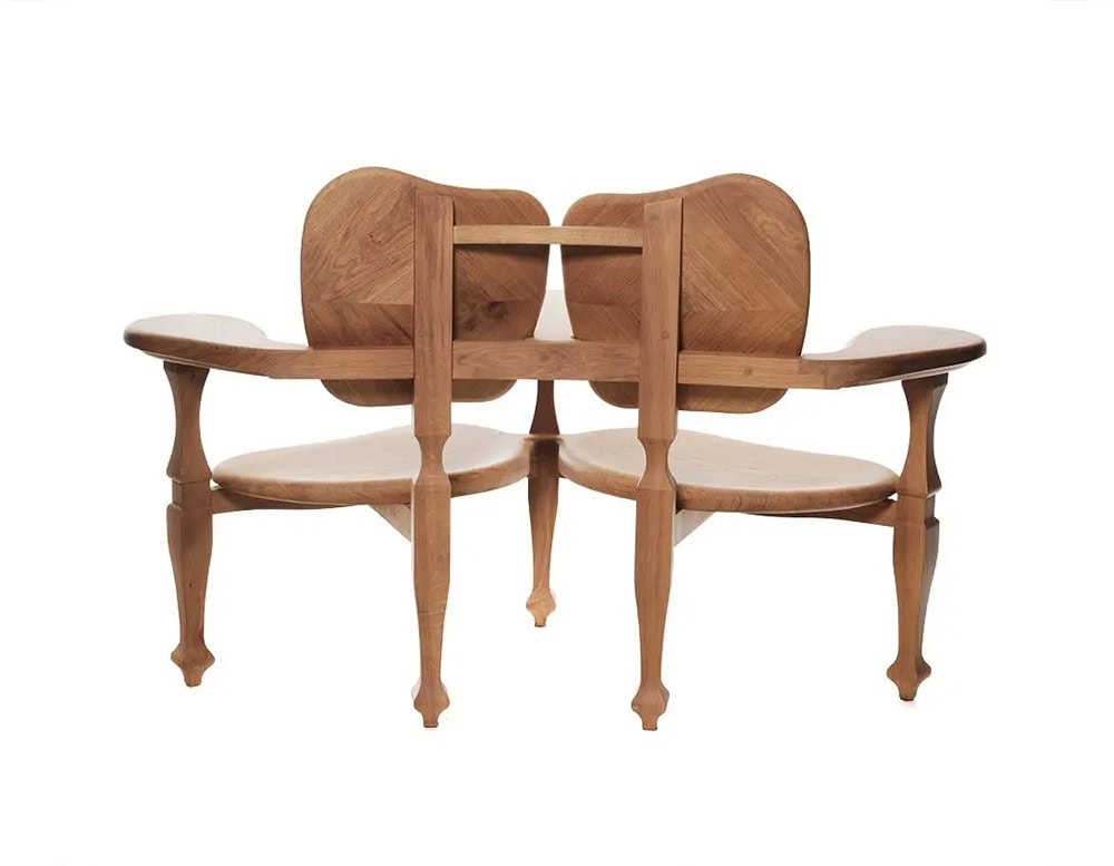 Rear view of the BD Batllo Bench in light oak wood, emphasizing the sculptural joinery, elegantly curved backrests, and artisanal craftsmanship that defines its organic and ergonomic design.