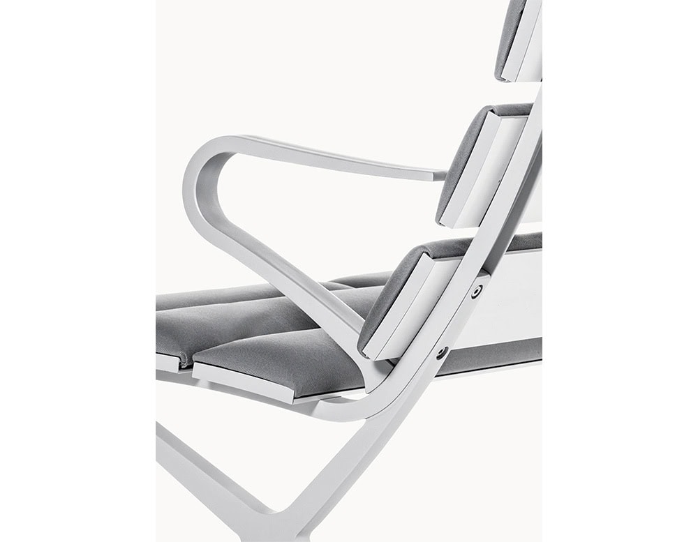The BD Bench B Outdoor presents a close-up of its curved aluminum armrest and plush grey cushions, combining ergonomic comfort with sleek, contemporary lines.