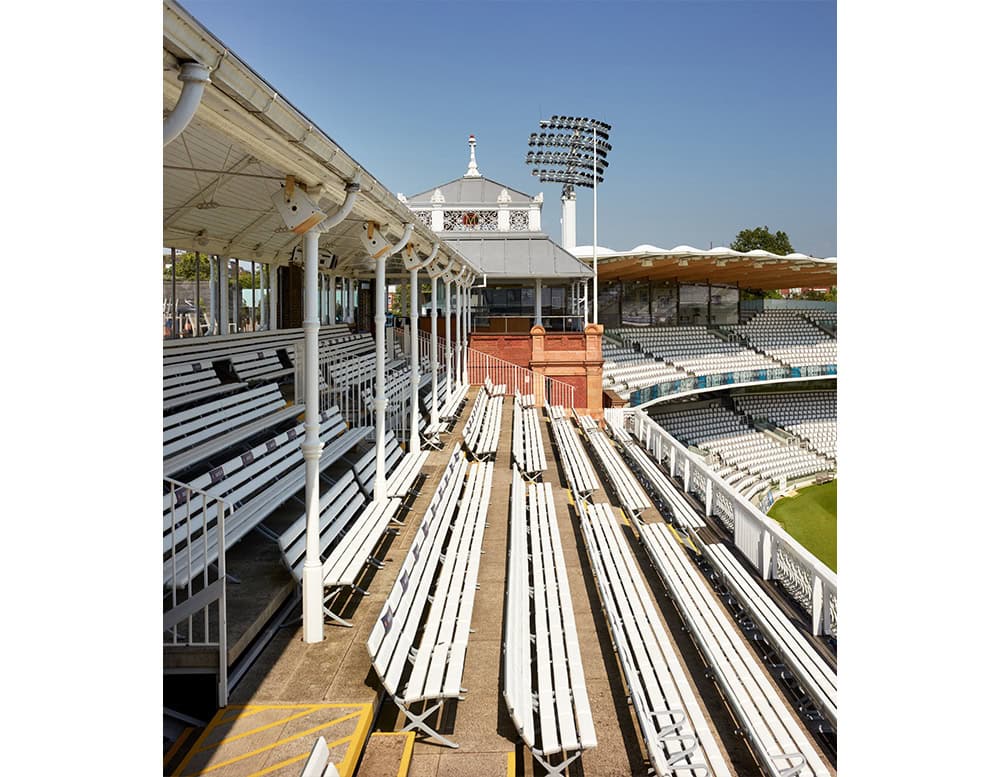 The BD Bench B Outdoor is installed across stadium seating, providing streamlined aluminum benches with minimalistic profiles, designed for durability and consistent visual rhythm in large public venues.
