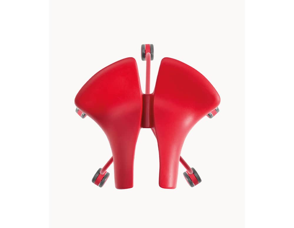 The BD Binaria Stool features a dynamic red saddle seat design with a five-wheel base, emphasizing its sculptural form and ergonomic functionality.