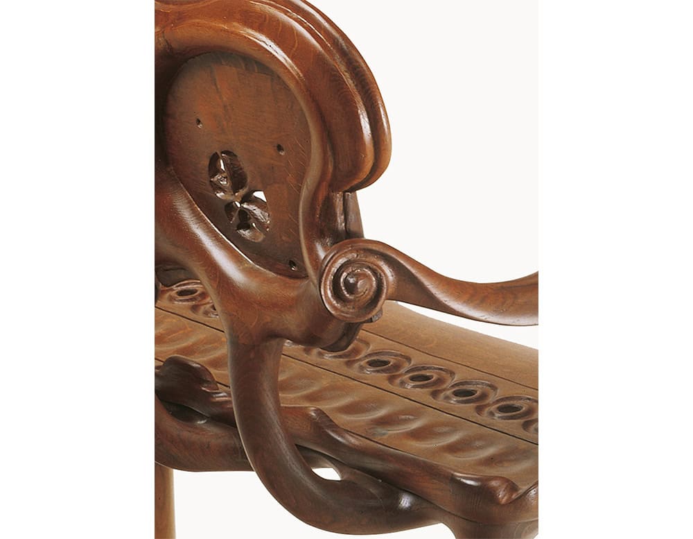 This detailed view highlights the BD Calvet Bench, emphasizing the flowing armrest design and detailed carved backrest. The organic lines and smooth curves display exceptional craftsmanship and a sculptural wood aesthetic.