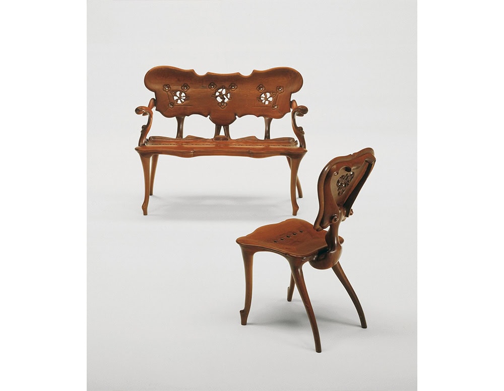 Presented as a complementary pair, the BD Calvet Bench and Chair highlight their sinuous wooden silhouettes and intricate carved motifs. The duo embodies an organic, sculptural approach to seating design, both ornamental and functional.