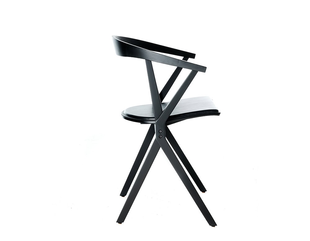 A side profile of the BD Chair B highlights its distinctive X-shaped frame and seamless folding system, combining ergonomic design with practical versatility.