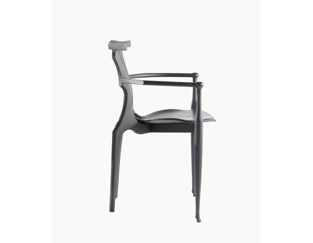 Side profile of the black BD Gaulino Chair emphasizing its slender silhouette, ergonomic curves, and elegant craftsmanship.