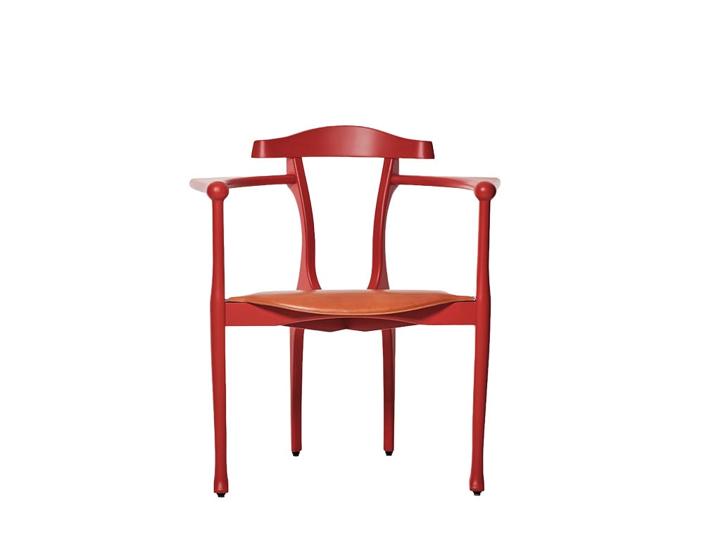 Symmetrical, sculpted red frame with gently flared legs and rounded armrests. The tan leather seat adds warmth and comfort to its refined, artistic silhouette.