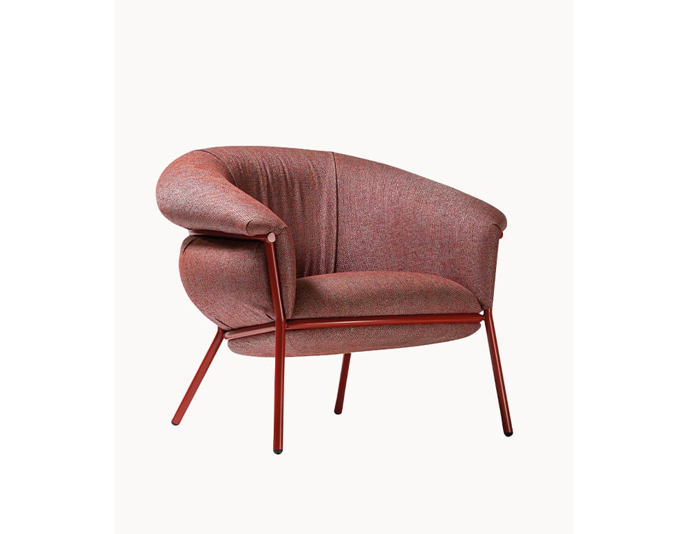 The BD Grasso Armchair is featured in a red textured fabric with a matching red metal structure. Its intentionally oversized cushions drape generously over the frame, enhancing both its bold visual impact and seated comfort.